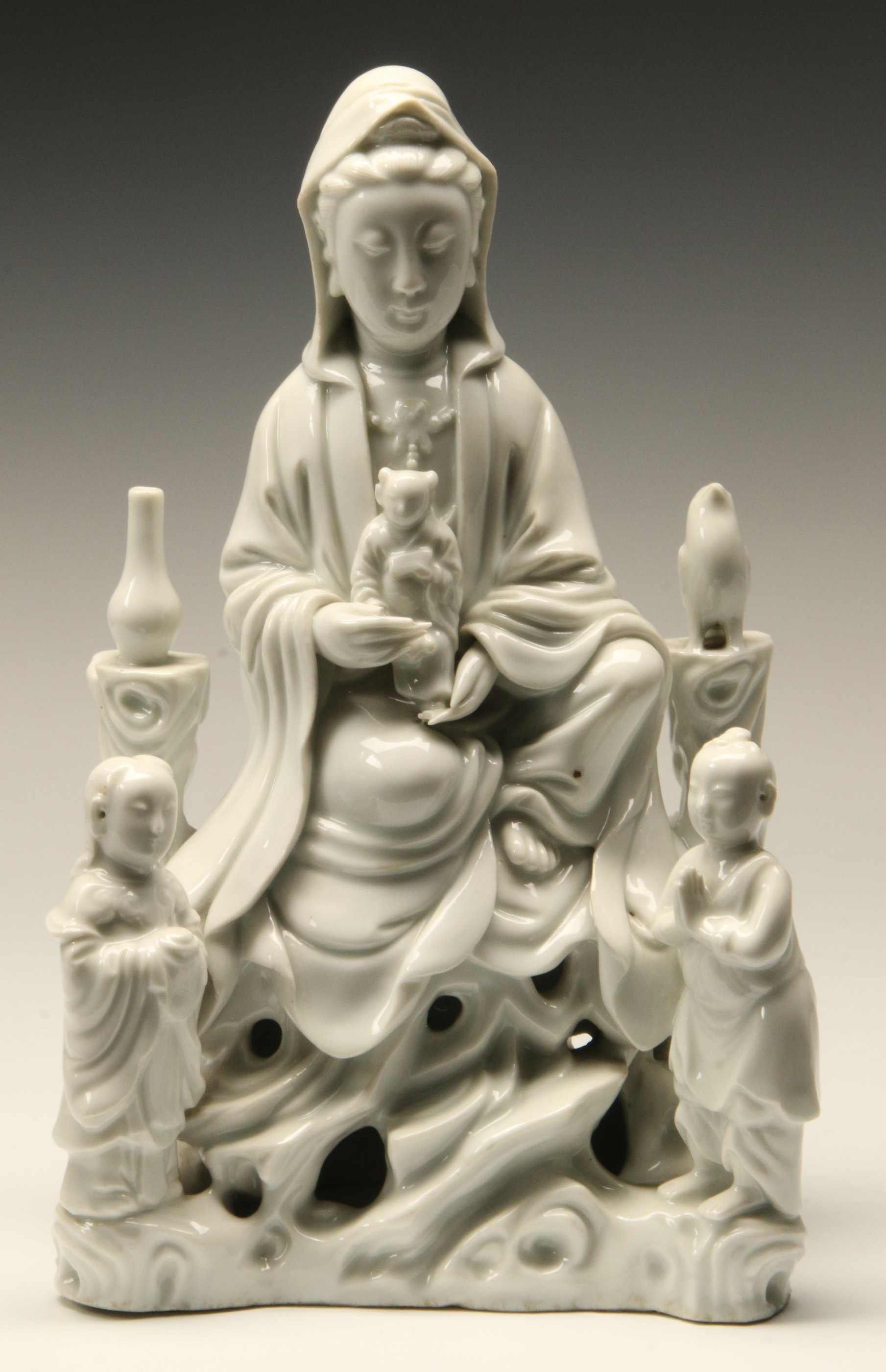 A CHINESE PORCELAIN GROUP OF GUANYIN AND CHILDREN