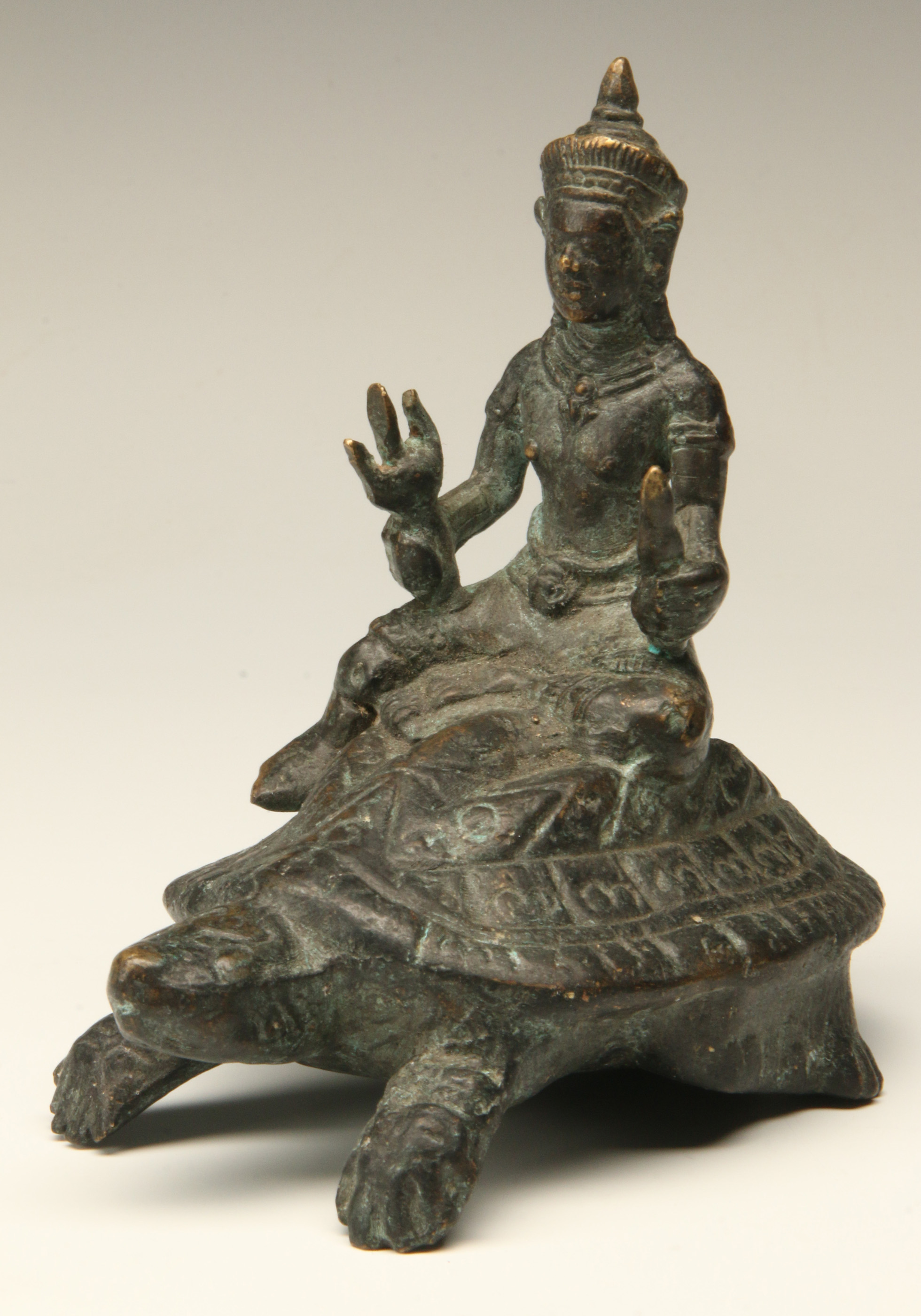 A SOUTHEAST ASIAN BRONZE BODHISATTVA SEATED ON TUR