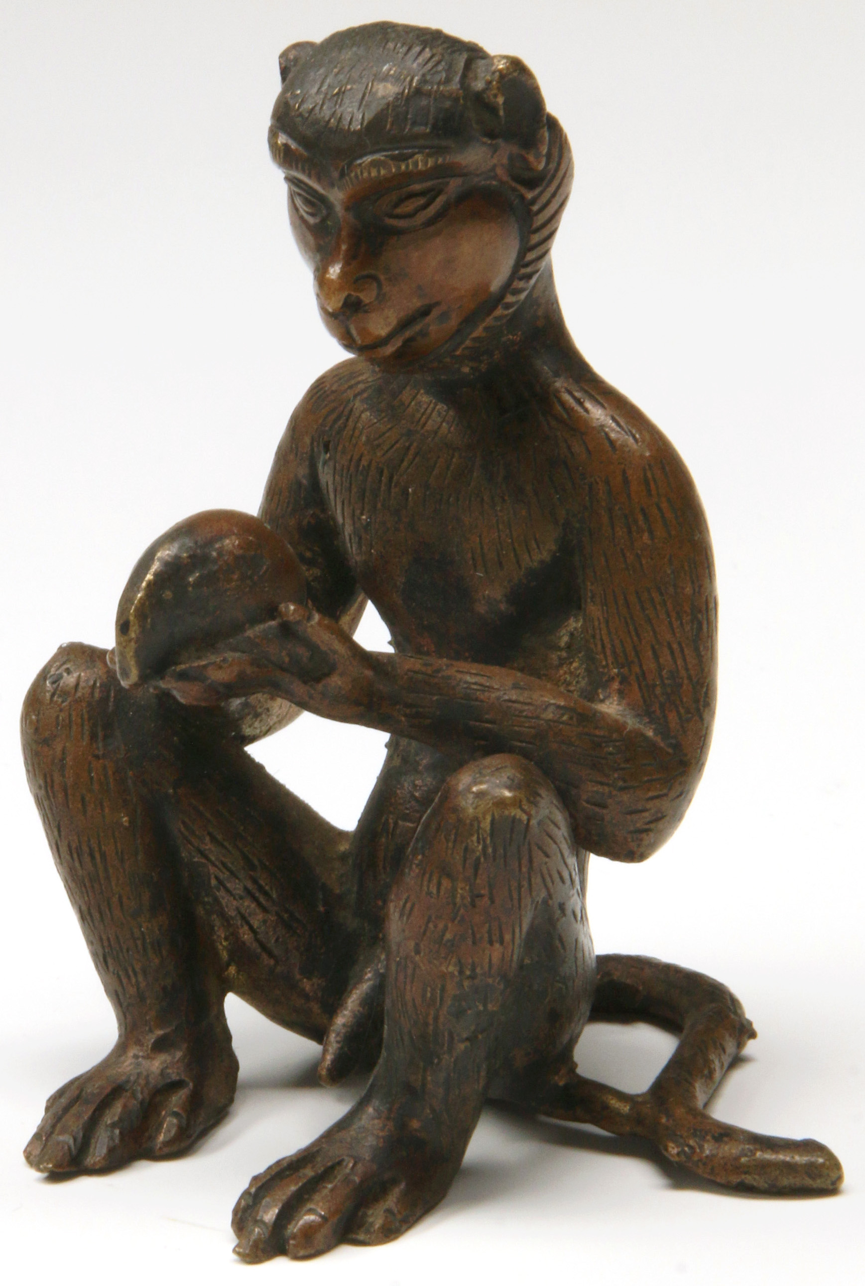 A SMALL ASIAN BRONZE MONKEY FIGURINE