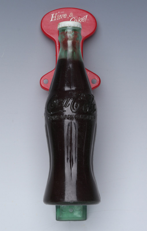 A CIRCA 1950 COCA-COLA FIGURAL BOTTLE DOOR HANDLE