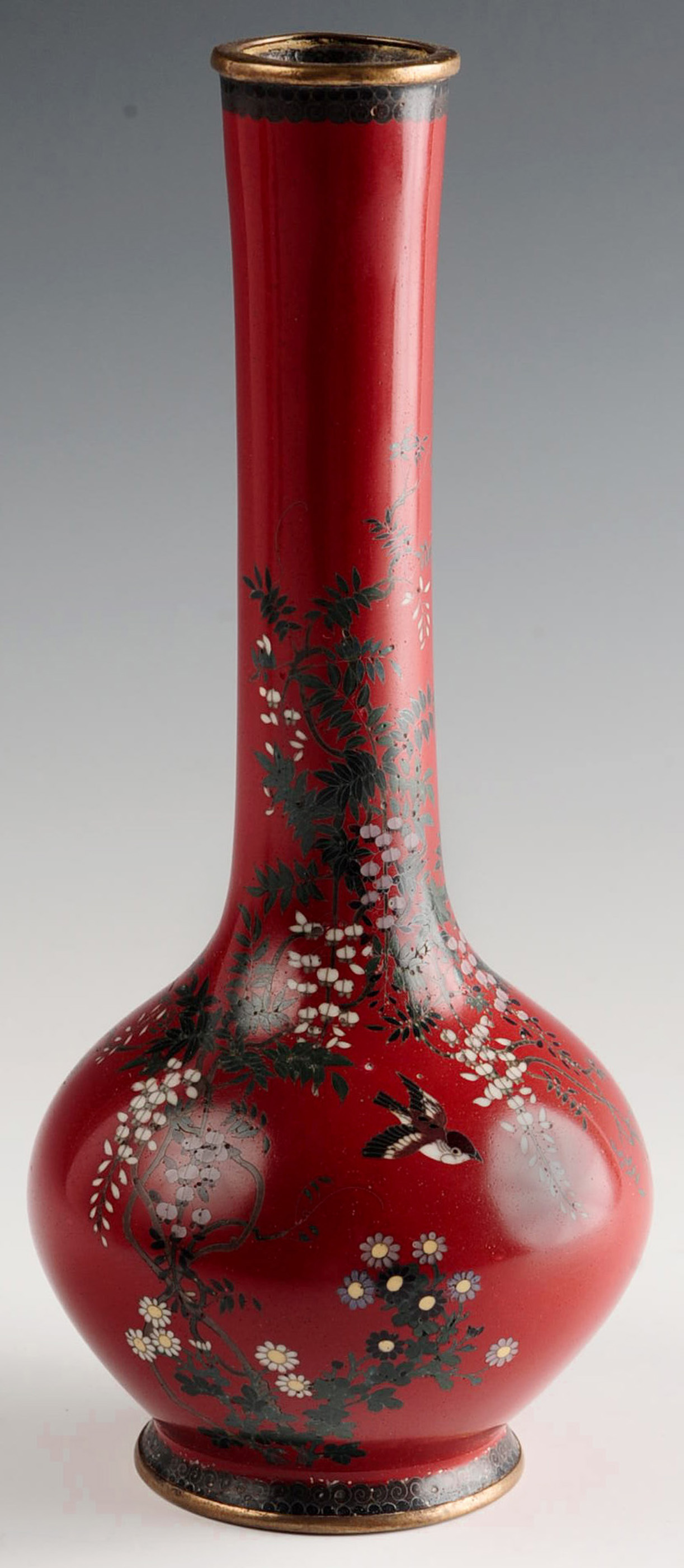 A MEIJI PERIOD JAPANESE RED GROUND CLOISONNE VASE