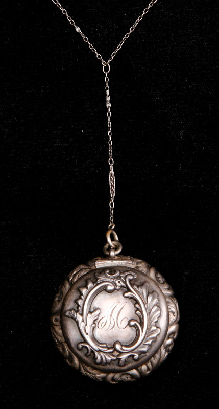 A CIRCA 1900 STERLING SILVER COIN BOX LAVALIER