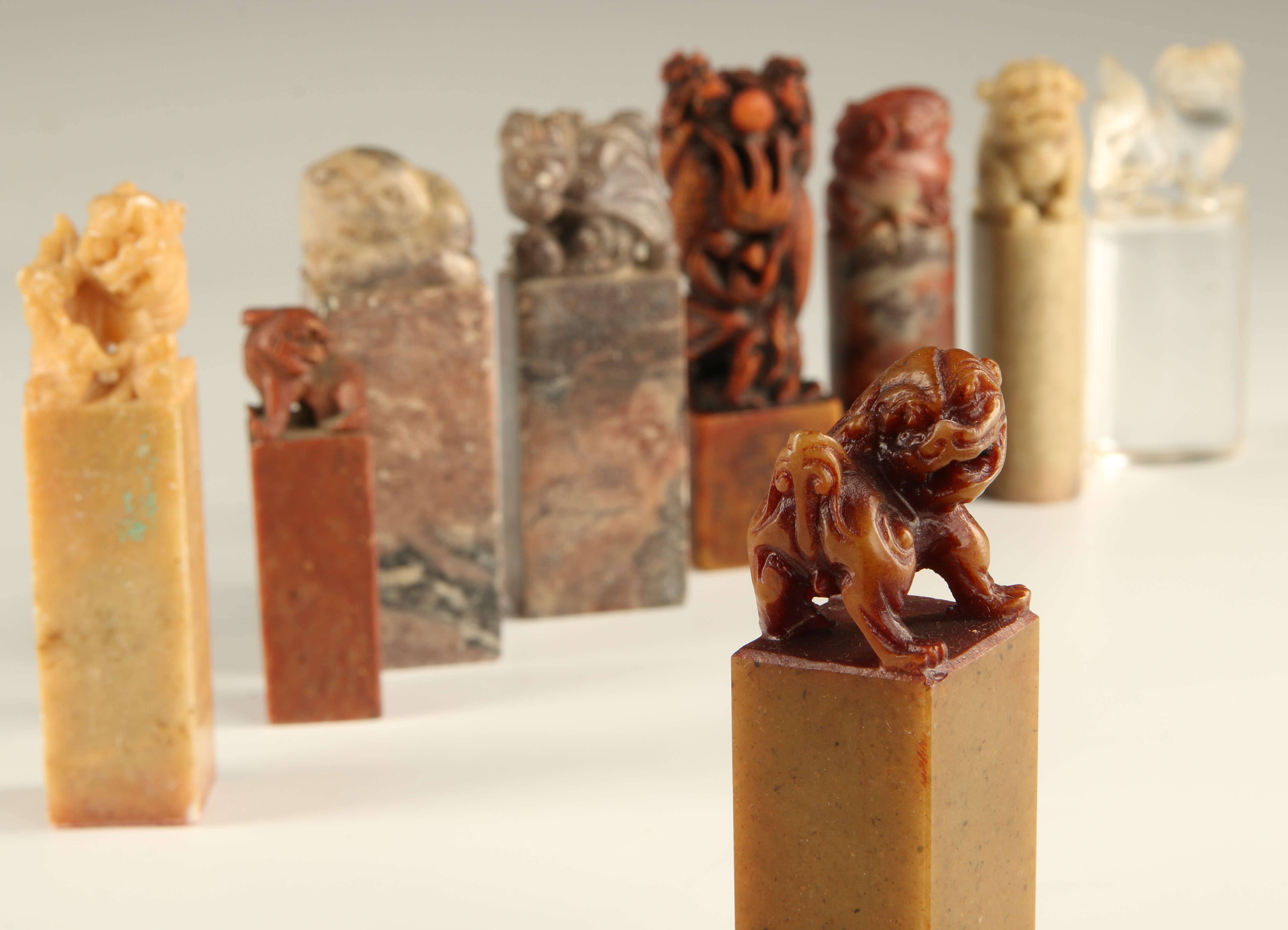 NINE CHINESE CARVED HARDSTONE SEALS WITH FU DOG