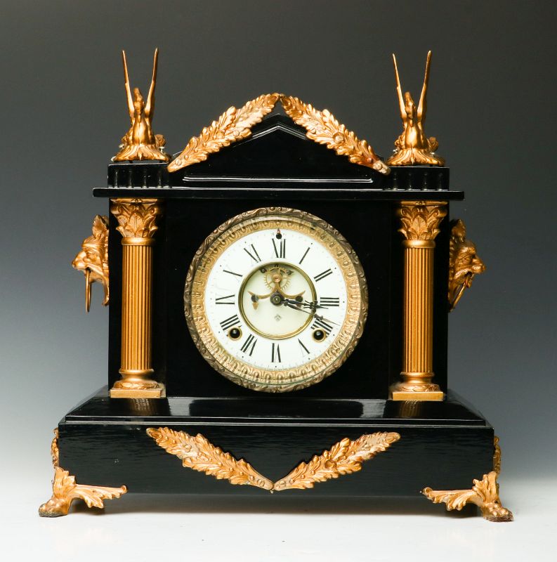 AN ANSONIA ENAMELED IRON CLOCK WITH SWANS