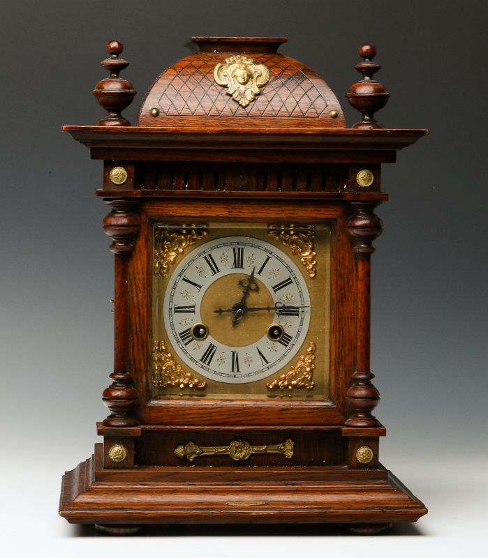 A JUNGHANS BRASS MOUNTED OAK BRACKET CLOCK