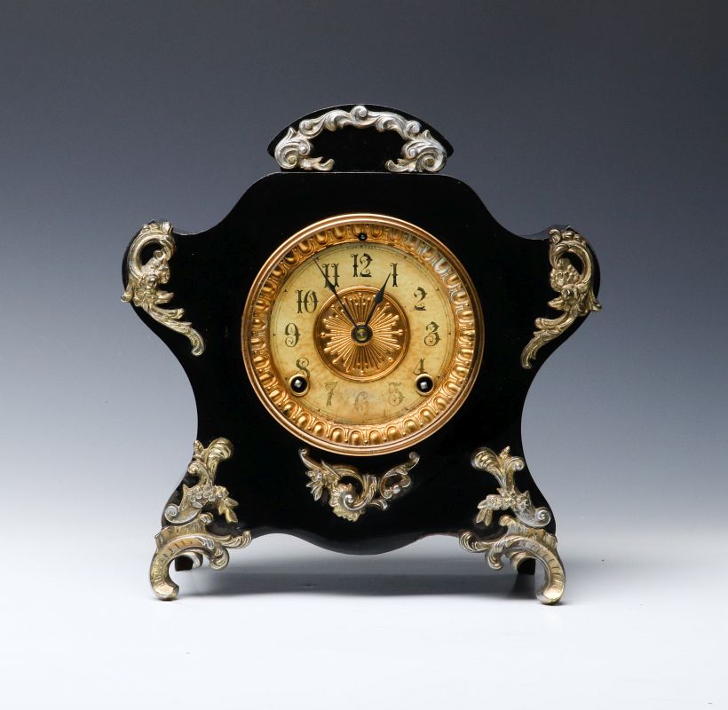 AN ANSONIA BLACK ENAMELED SHELF CLOCK