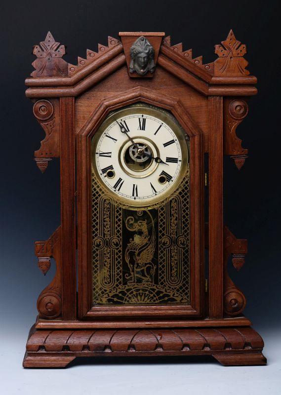 AN ORNATE WALNUT PARLOR CLOCK ATTRIBUTED INGRAHAM