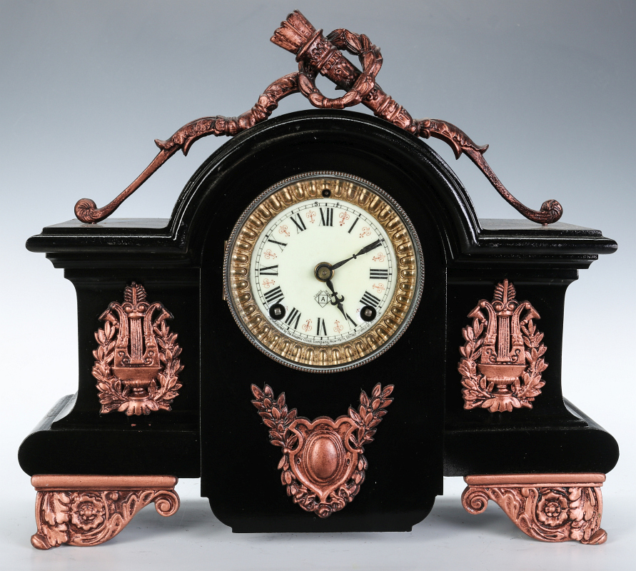 AN ANSONIA BLACK ENAMEL IRON MANTLE CLOCK