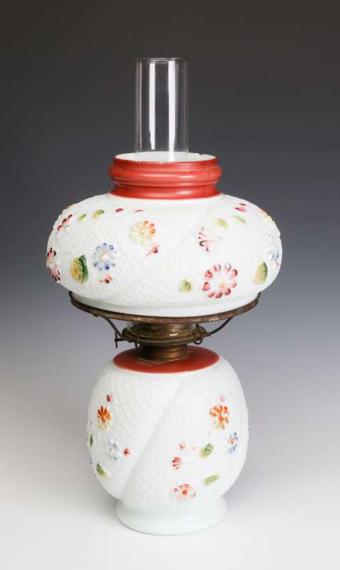 AN ANTIQUE MILK GLASS LAMP SIMILAR TO COSMOS