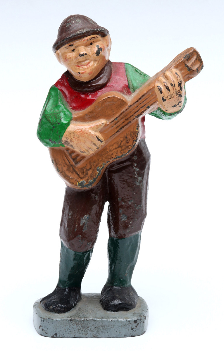 A CAST IRON MAN PLAYING GUITAR DOORSTOP