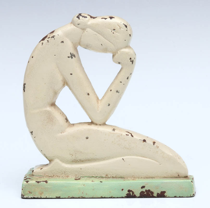 AN ART DECO KNEELING NUDE CAST IRON DOORSTOP