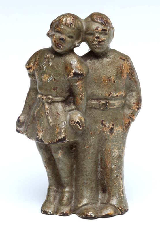 A CAST IRON BOY AND GIRL DOORSTOP, CIRCA 1930