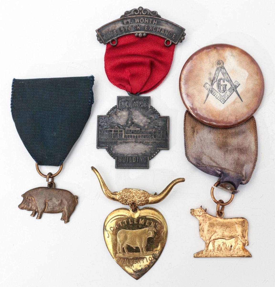 A COLLECTION OF FOUR STOCKMAN BADGES CIRCA 1900