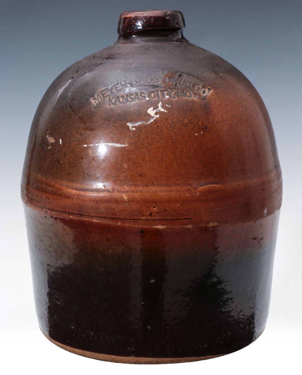 A 19TH C. MEYER DRUG K.C. STONEWARE LIQUOR JUG