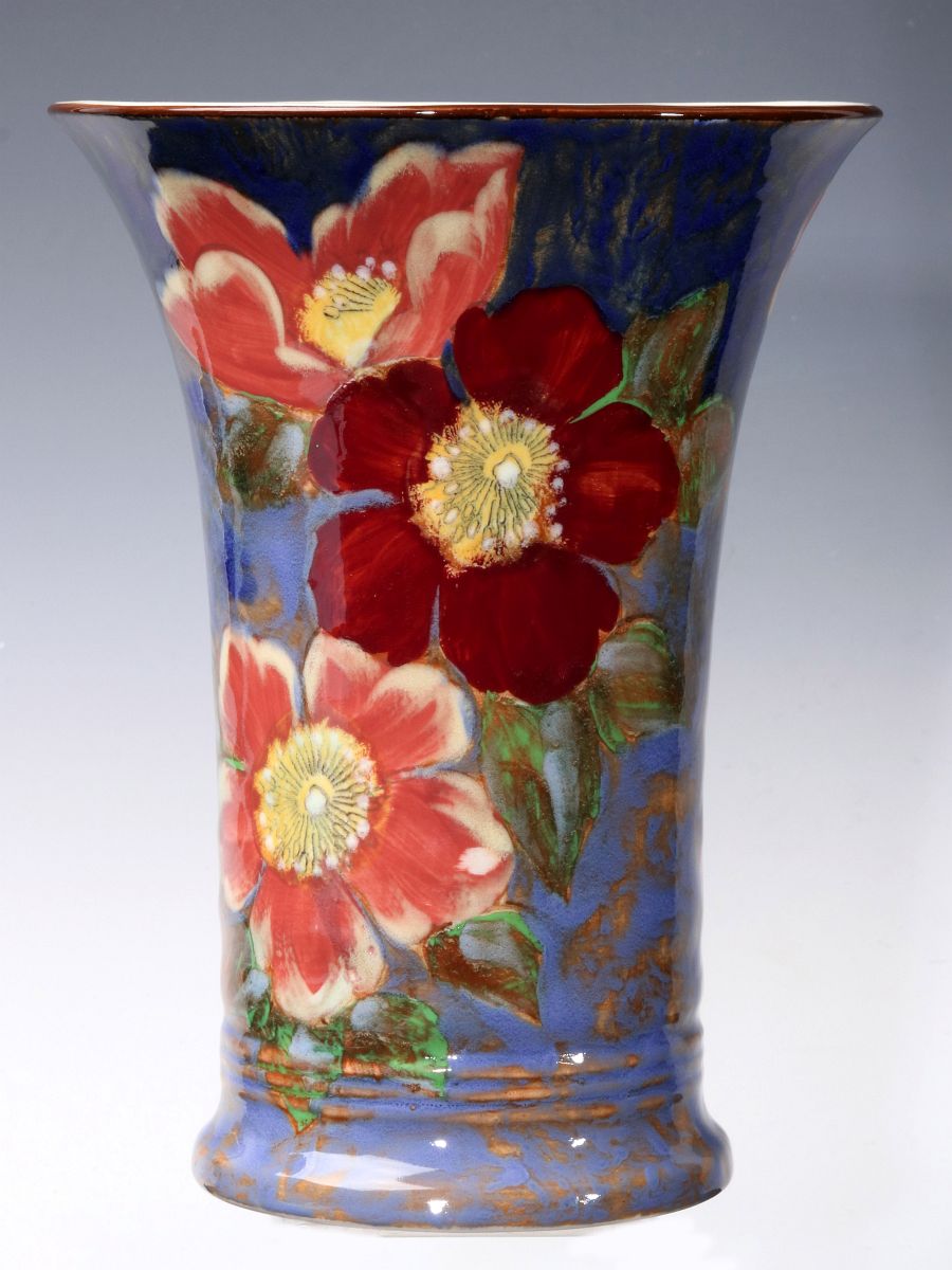 A ROYAL DOULTON FLORAL DECORATED TRUMPET VASE