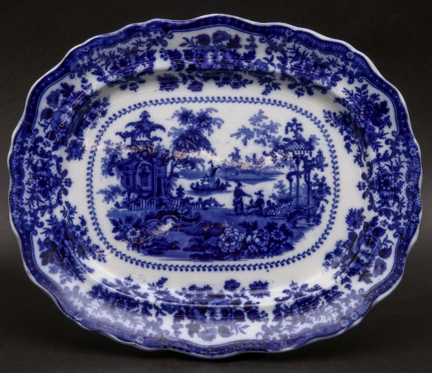 A 'FAIRY VILLAS' PATTERN FLOW BLUE PLATTER