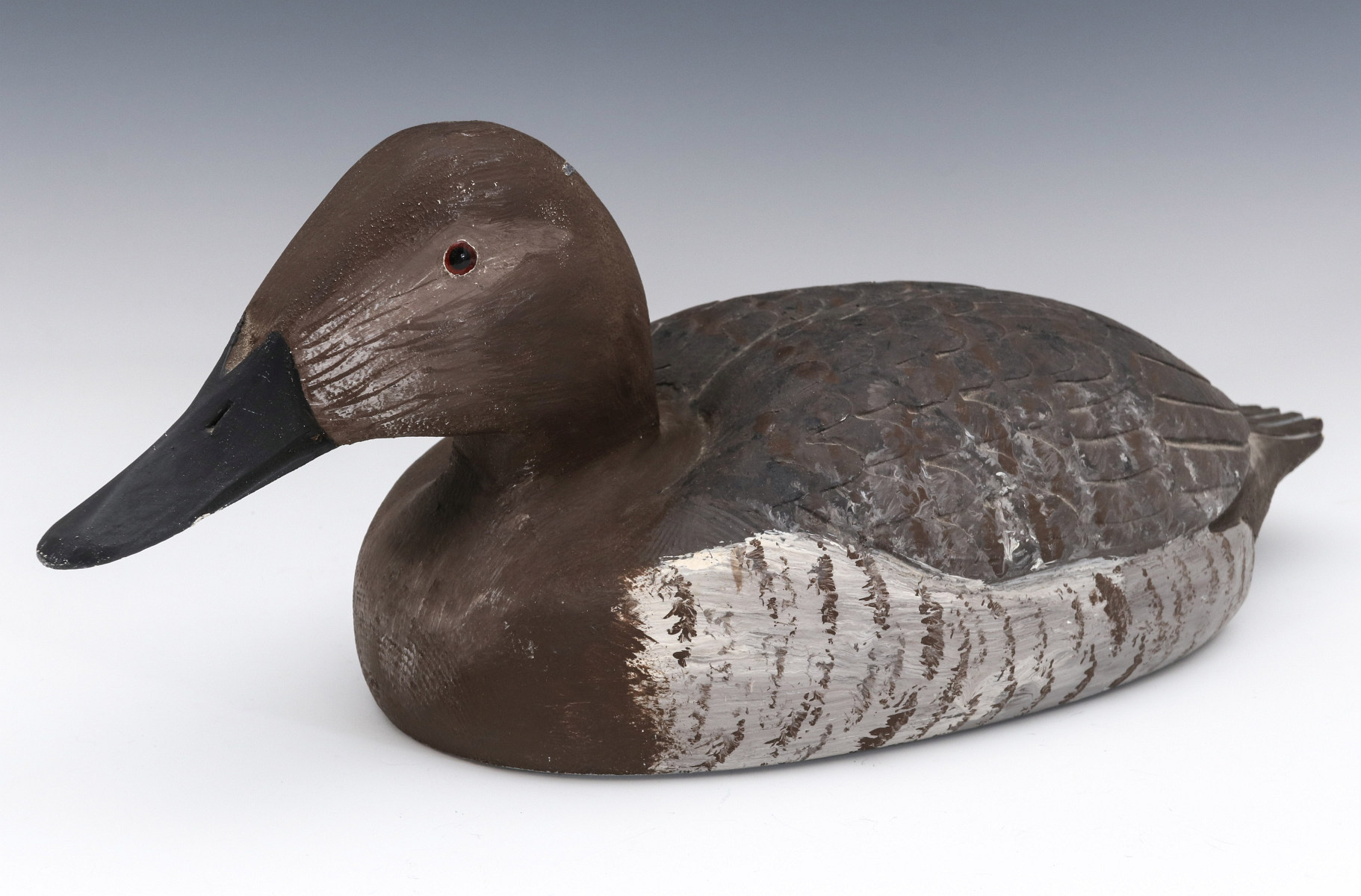 A CANVASBACK HEN DECOY SIGNED MELVIN J. PIGGOTT