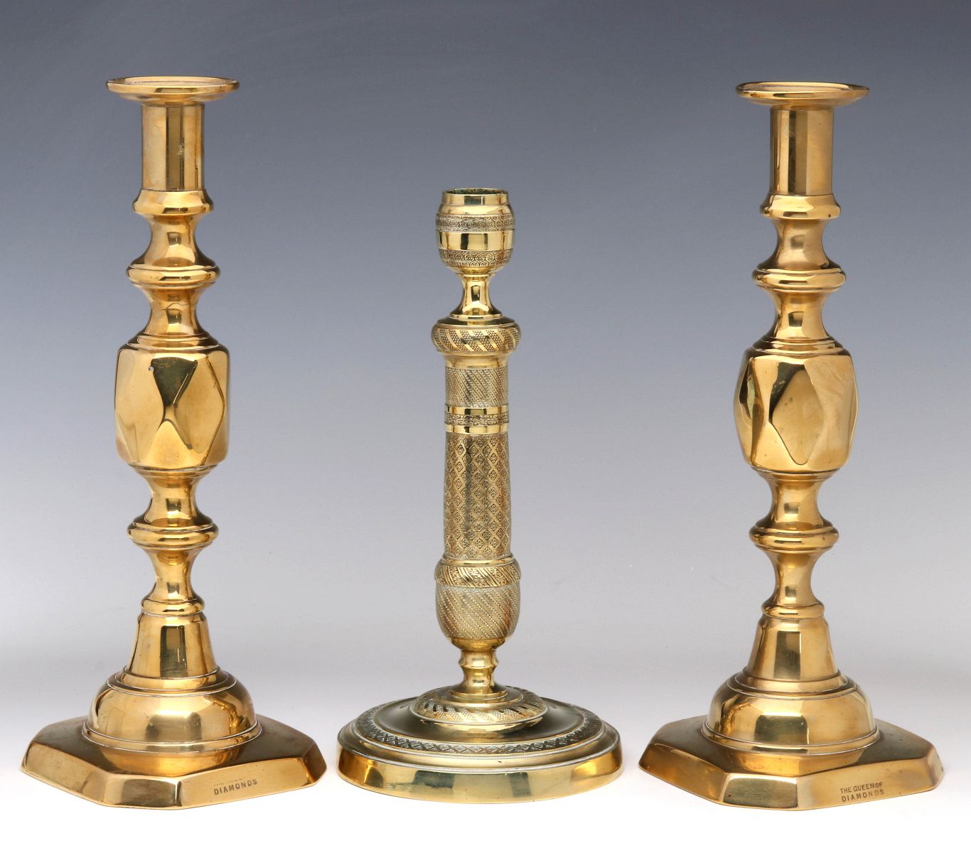 THREE EARLY BRASS CANDLESTICKS