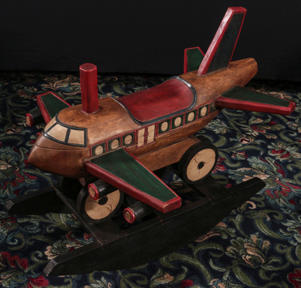 A CARVED AND PAINTED CHILD'S ROCKING RIDE-ON TOY