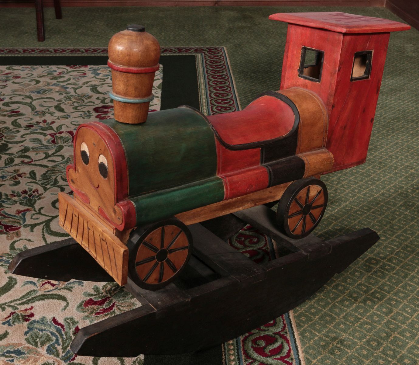 A CARVED AND PAINTED CHILD'S ROCKING RIDE-ON TOY