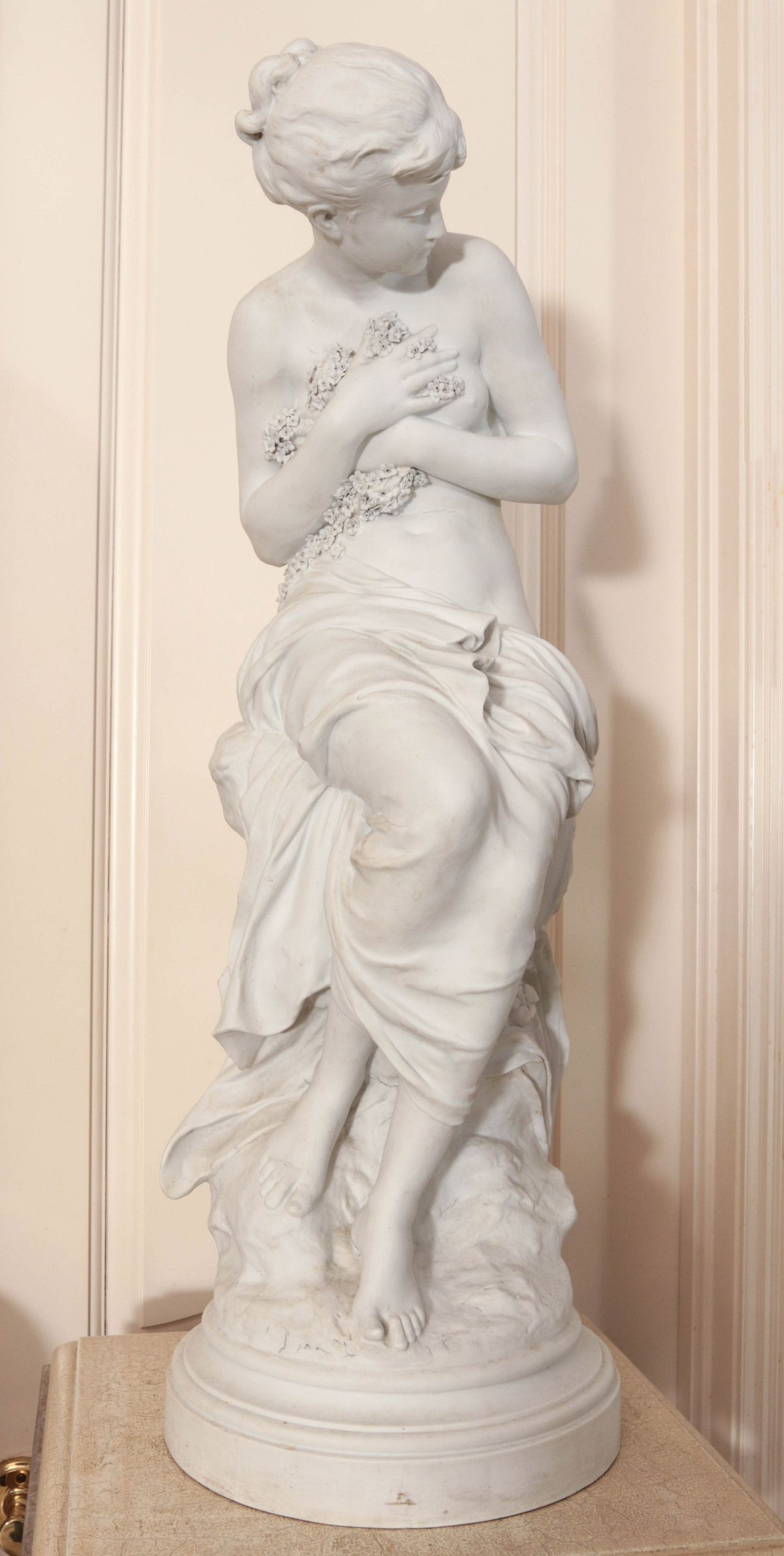 A 31-INCH BISQUE PORCELAIN FIGURE