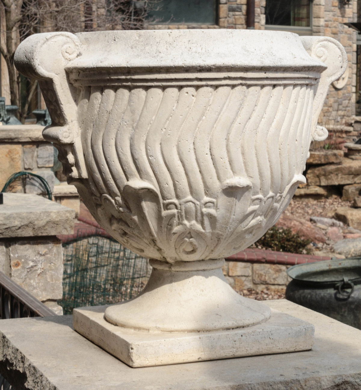 A CAST STONE GARDEN URN