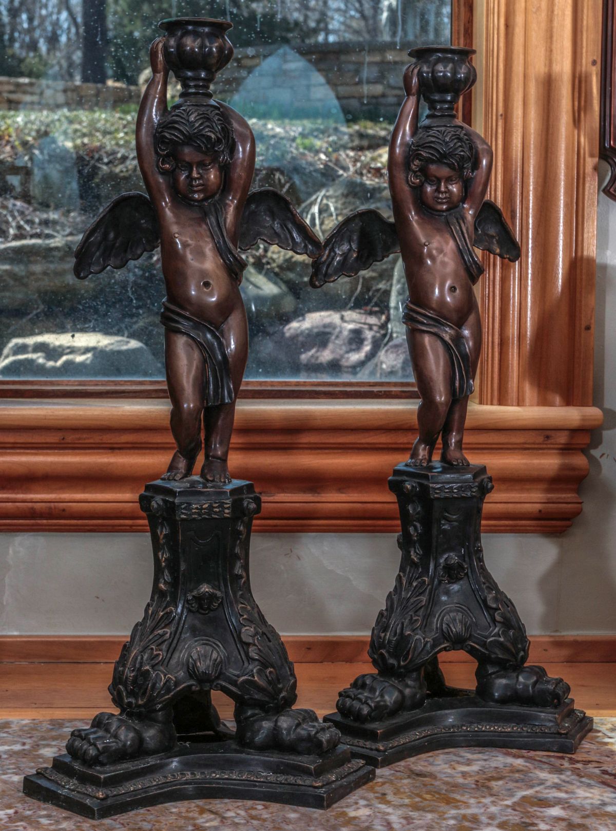 A PAIR 27-INCH BRONZE FIGURAL CHERUB CANDLESTICKS