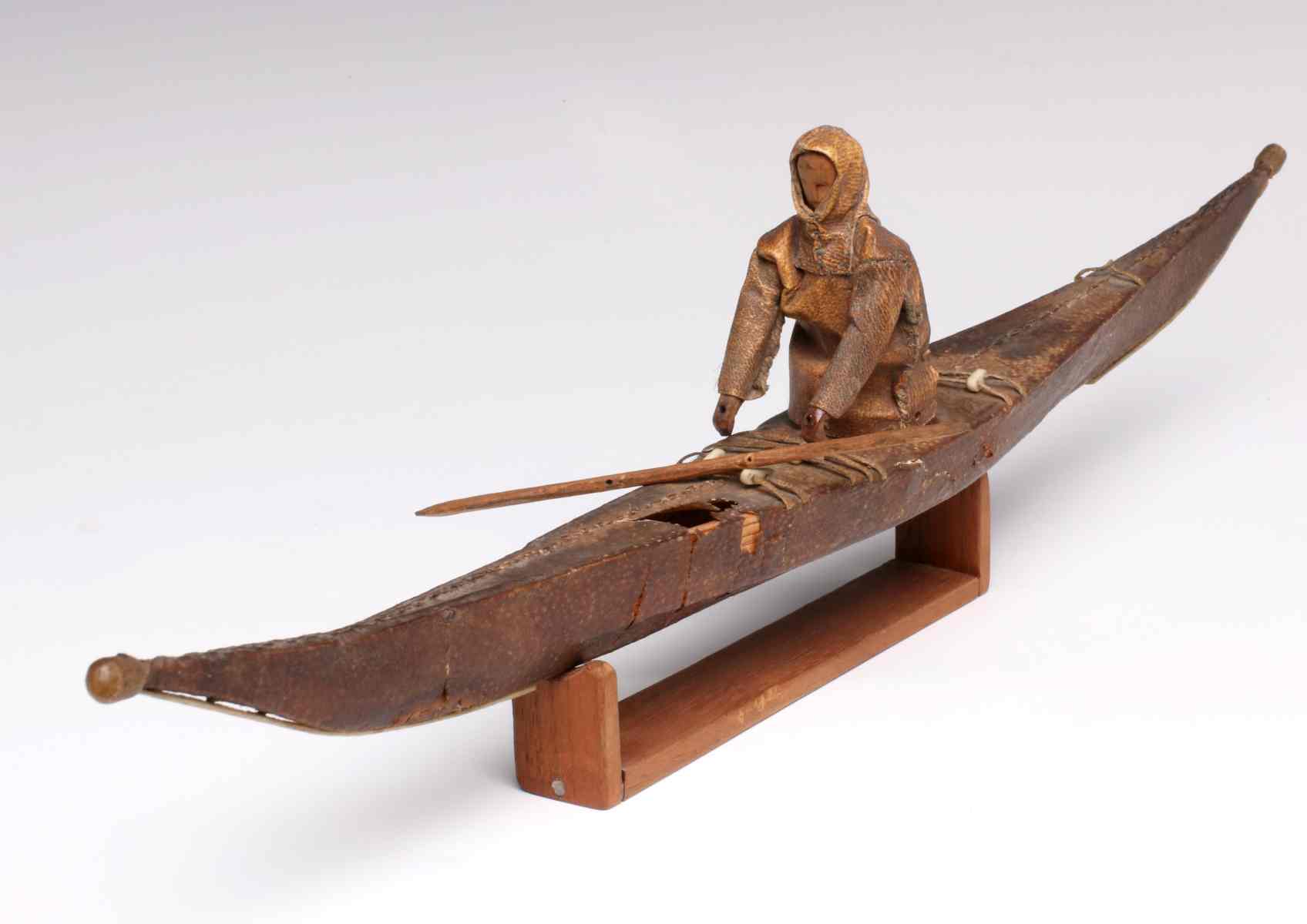 A GOOD 19TH CENT ESKIMO MODEL OF HUNTER IN KAYAK