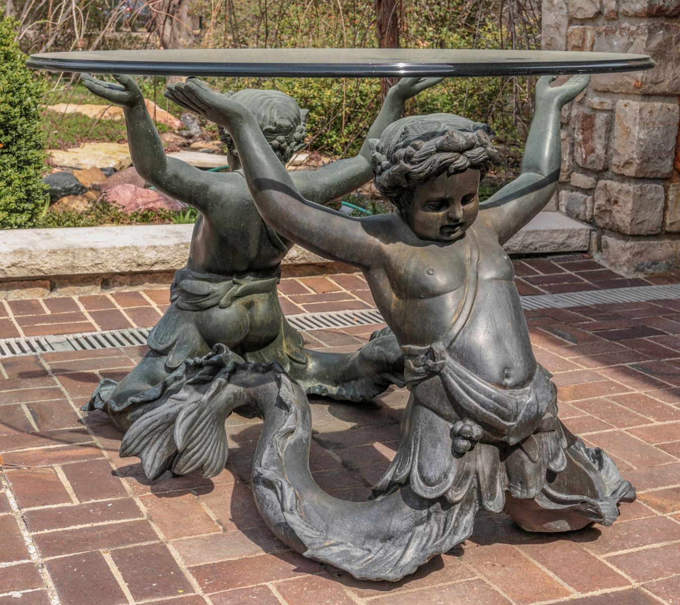 A LARGE CENTER TABLE WITH BRONZE MERMAN FIGURES