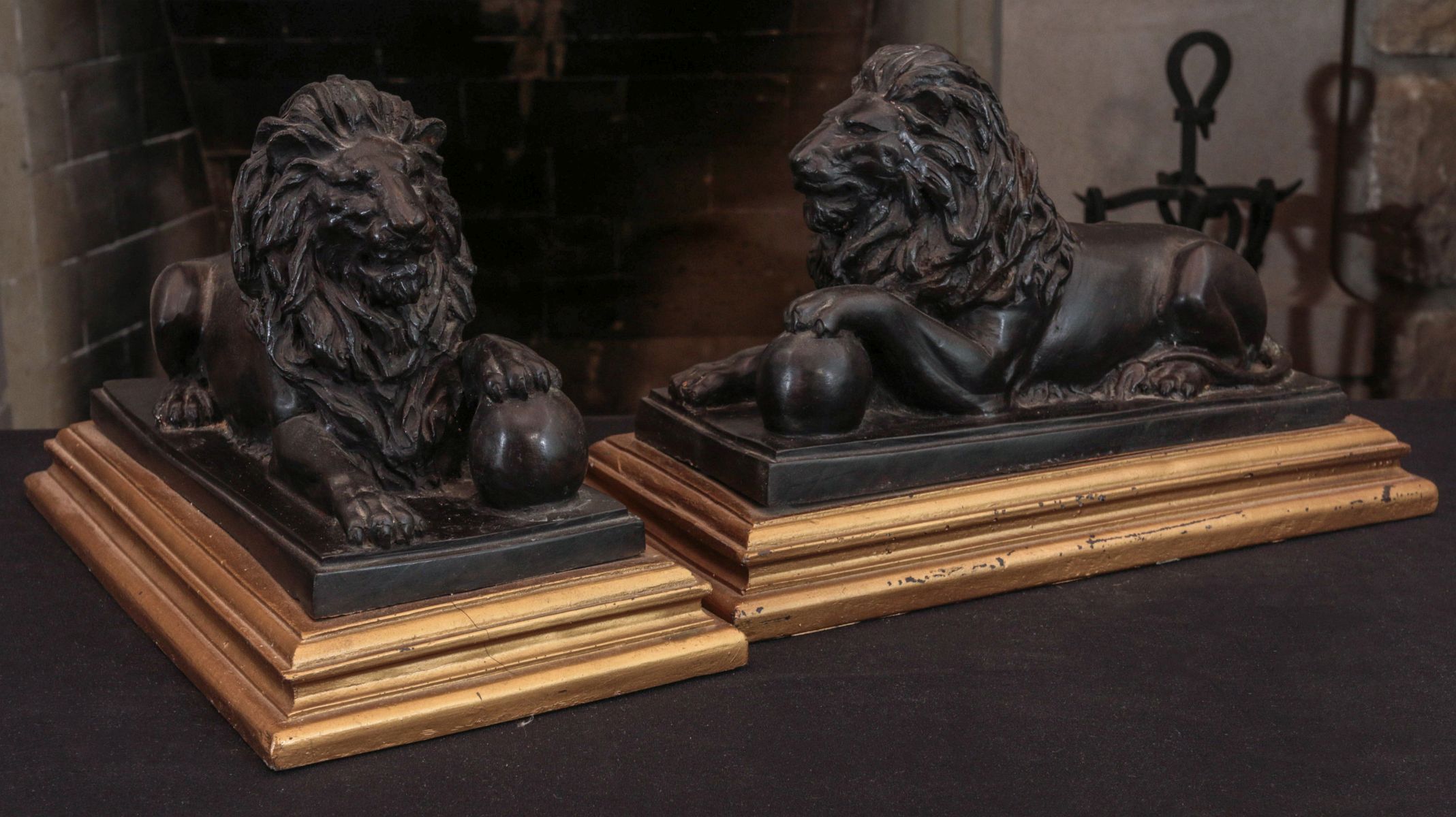 A PAIR OF DECORATIVE BRONZE LION FIGURES