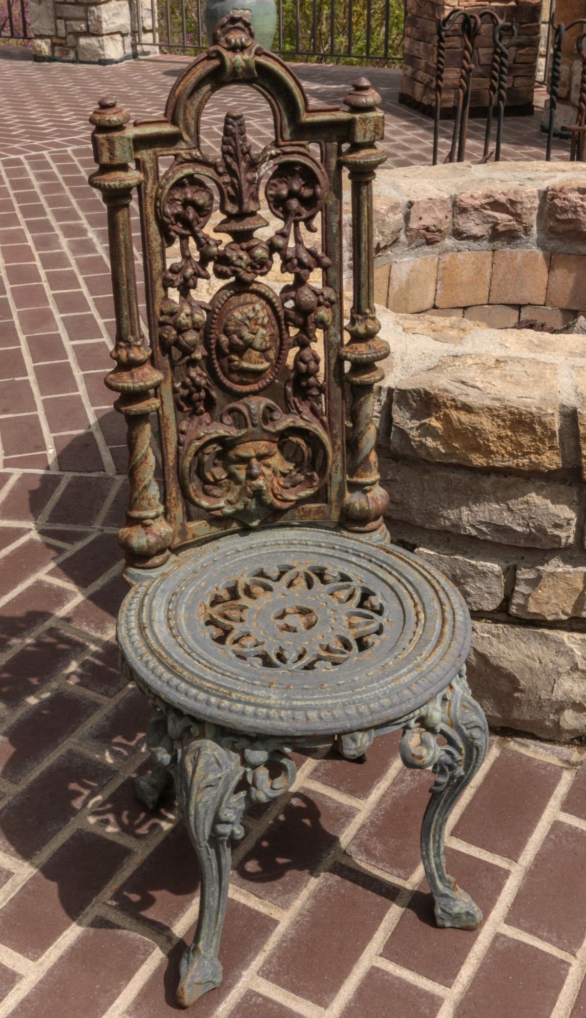 A PAIR OF GOTHIC REVIVAL STYLE IRON GARDEN CHAIRS