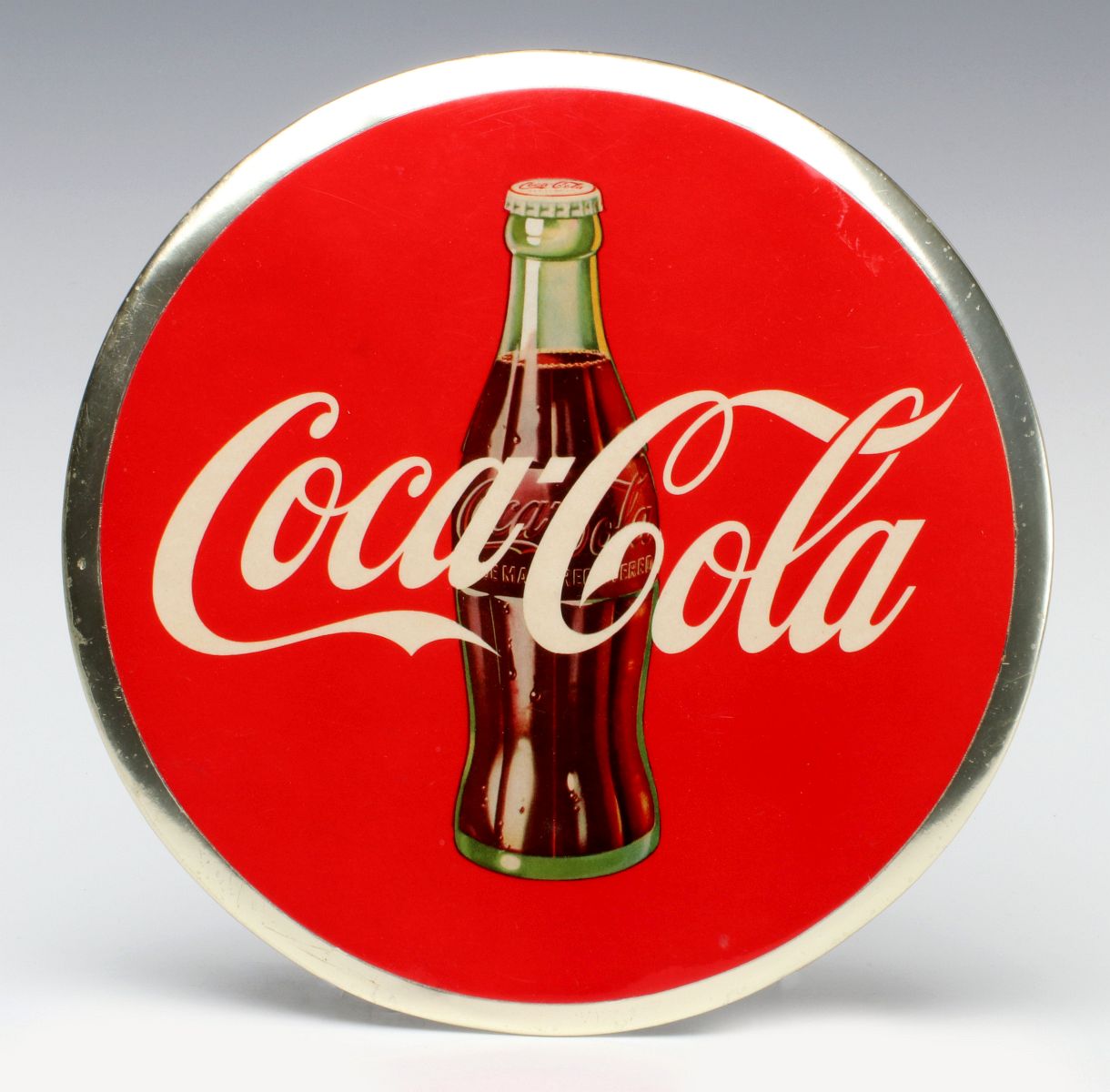 A 1950s COCA-COLA CELLULOID ADVERTISING SIGN