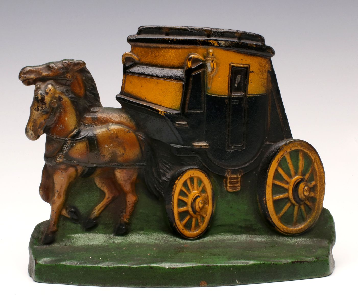 A SCARCE STAGECOACH CAST IRON DOORSTOP