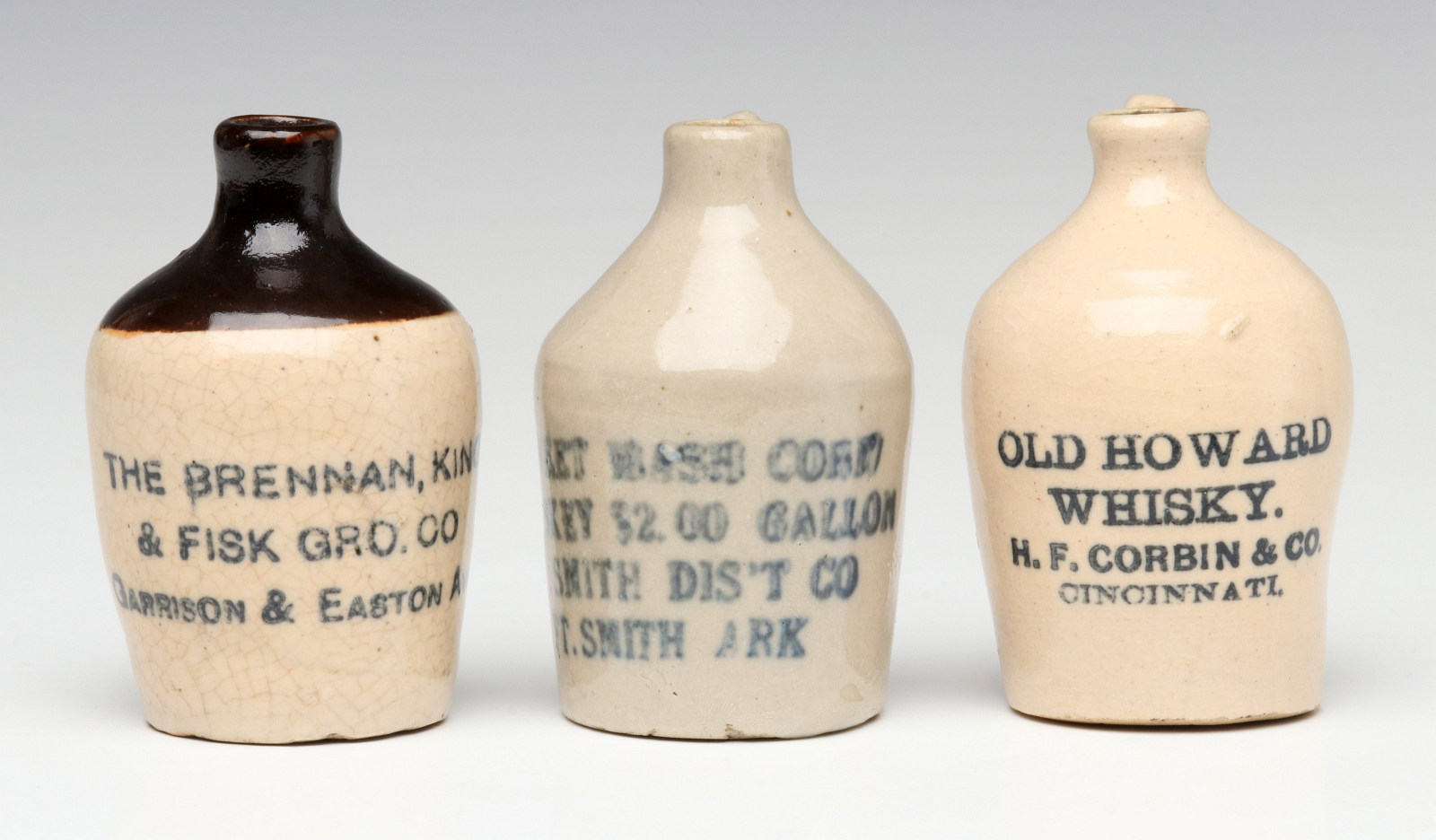 THREE STONEWARE MINI JUGS WITH WHISKY ADVERTISING