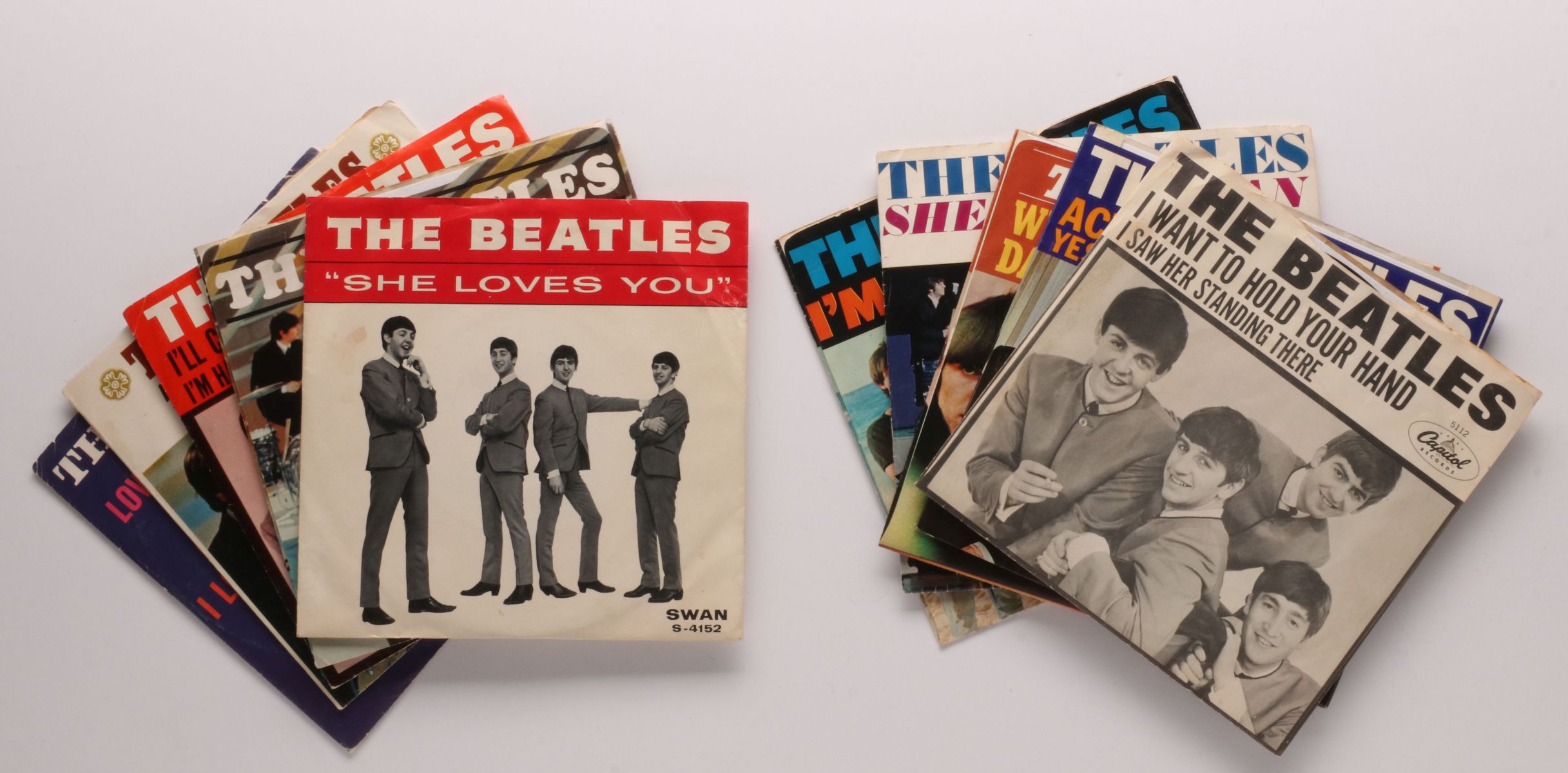 A COLLECTION OF BEATLES 45 RPM RECORDS AND SLEEVES