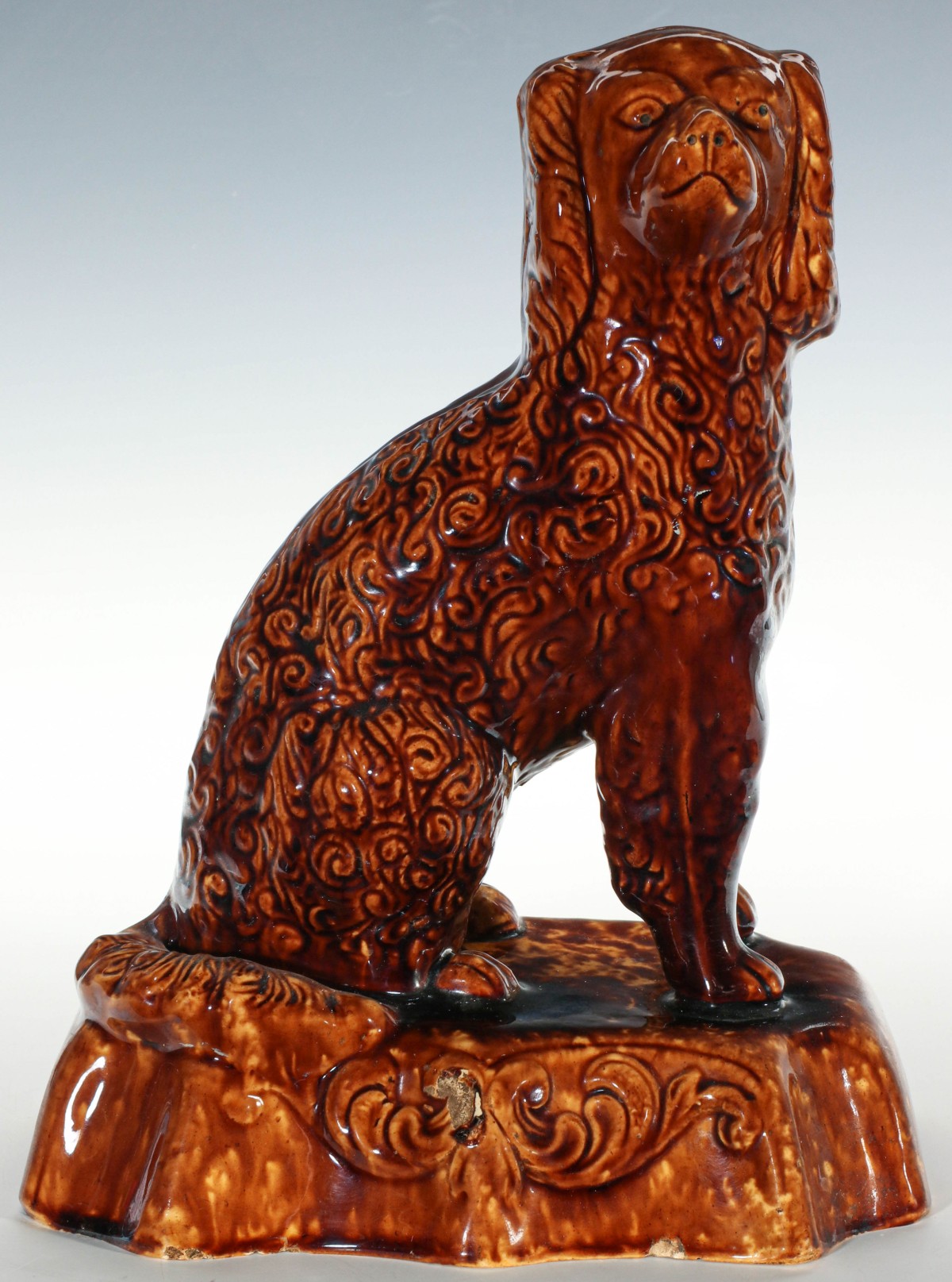 A 19TH C. YELLOWWARE SPANIEL WITH ROCKINGHAM GLAZE