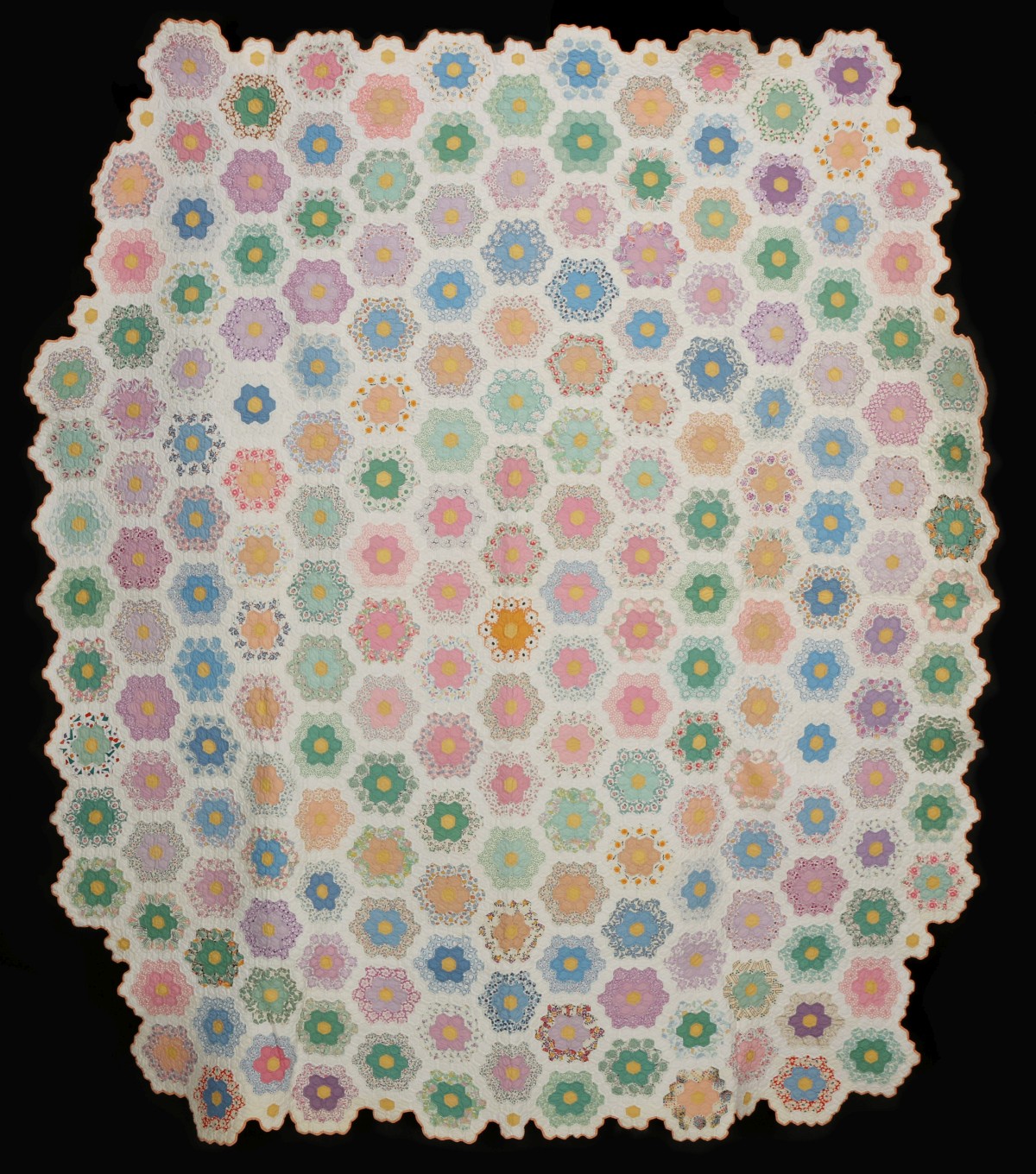 AN INTERESTING 1930s GRANDMOTHER'S FLOWER GARDEN QUILT