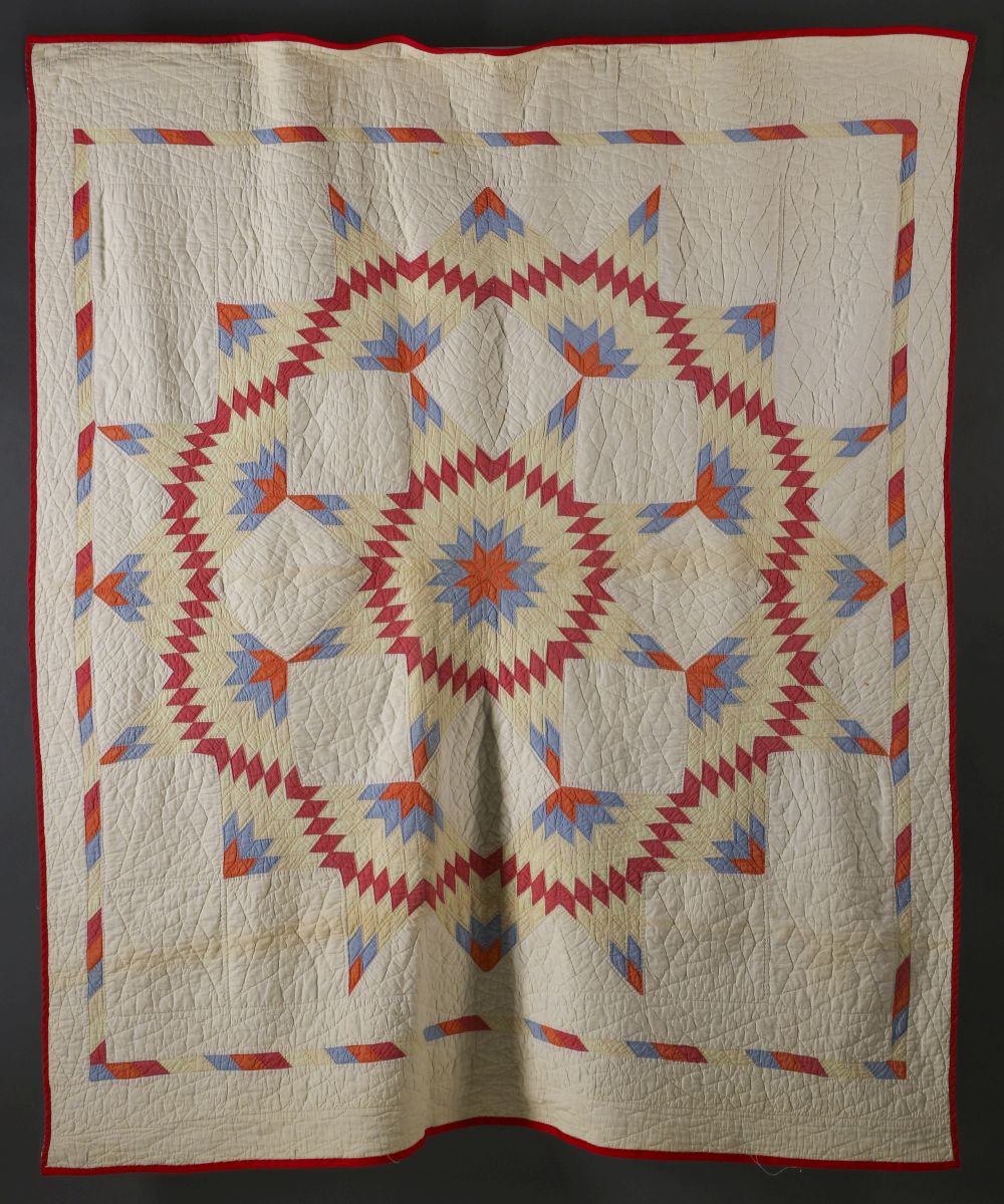 A VINTAGE 'BROKEN STAR' PATTERN QUILT