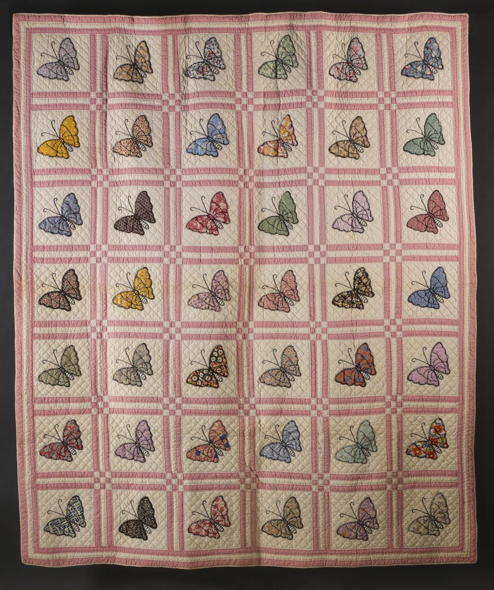 A 1930s FEEDSACK QUILT WITH APPLIQUE' BUTTERFLIES