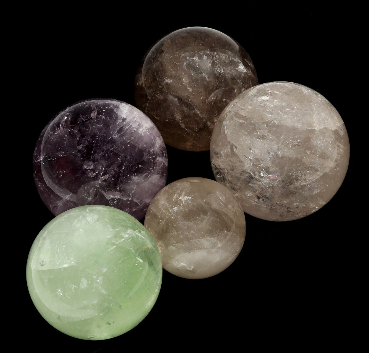 FIVE POLISHED QUARTZ ORBS