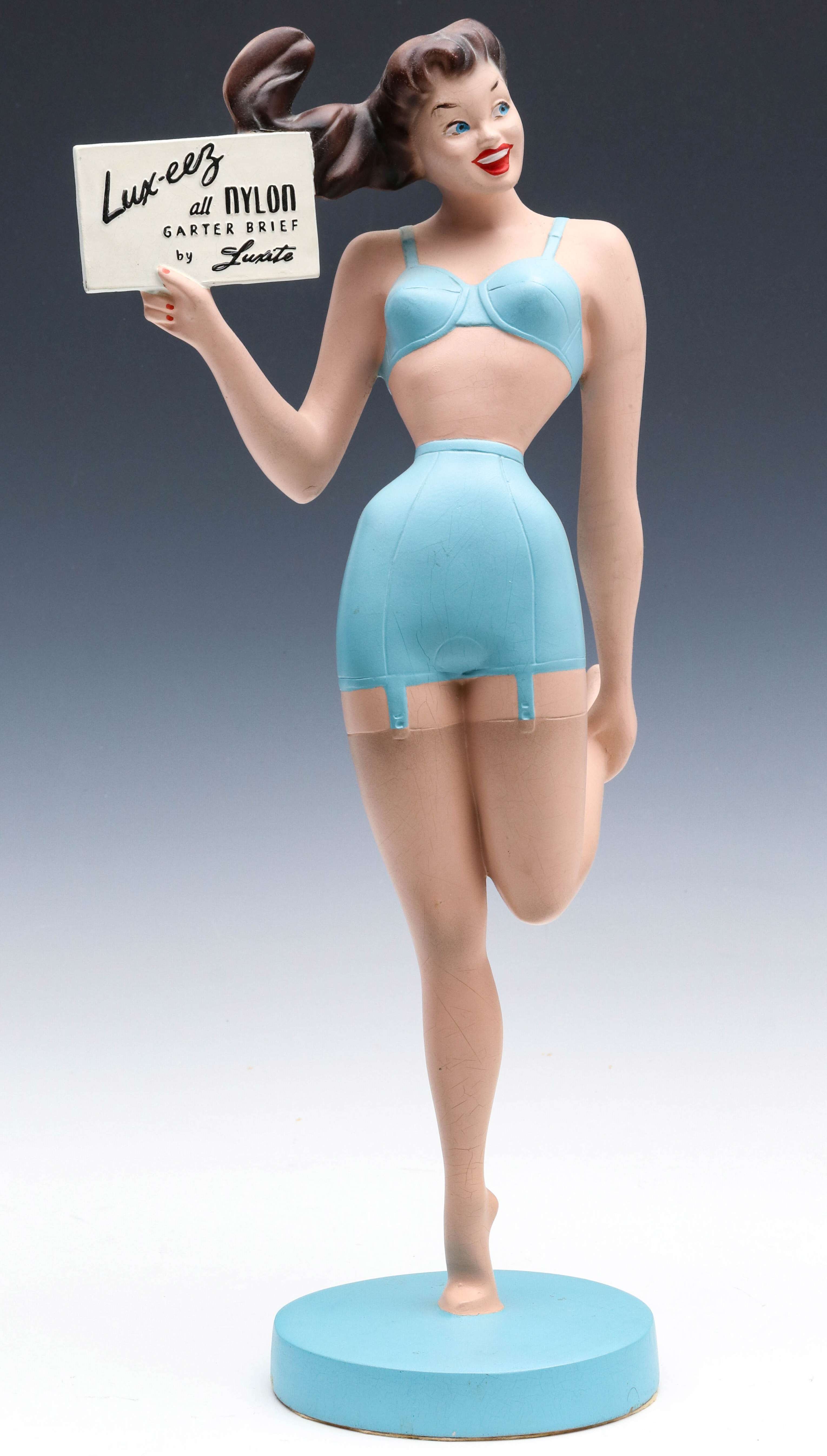 A MID 20TH CENT LUX-EEZ GARTER ADVERTISING FIGURE
