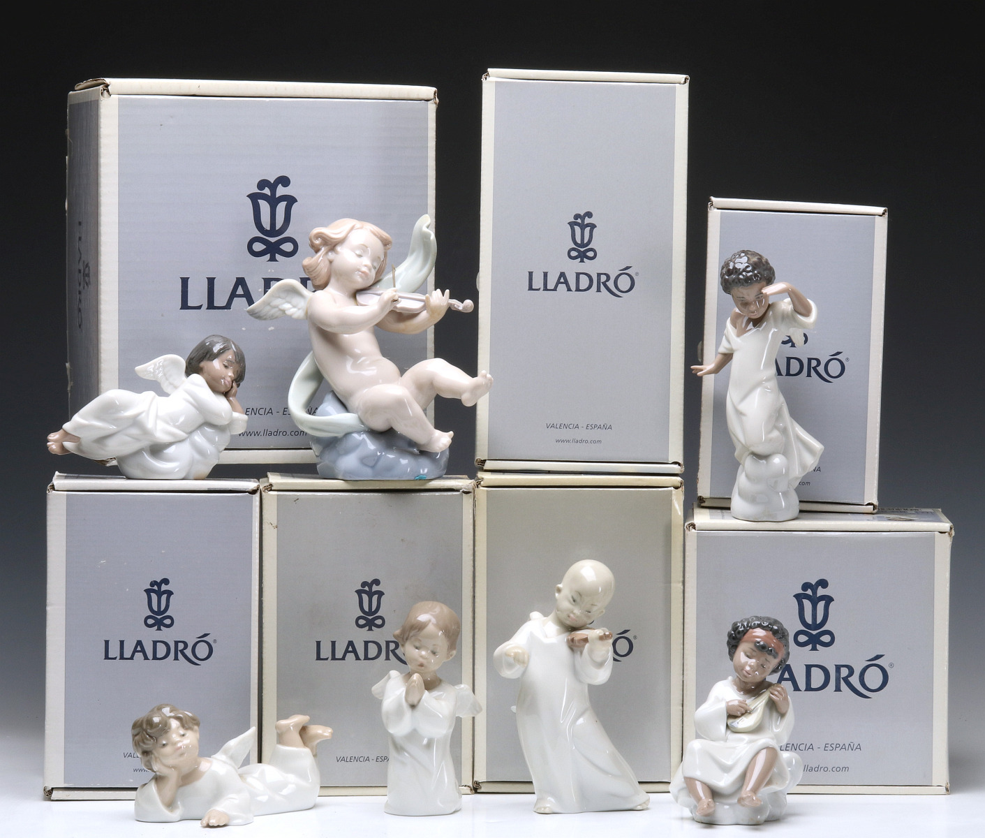 A COLLECTION OF SEVEN LLADRO ANGEL FIGURES WITH BOXES