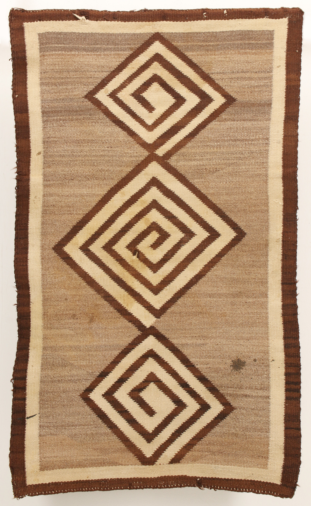 A NAVAJO RUG WITH THREE MAZE-LIKE MEDALLIONS