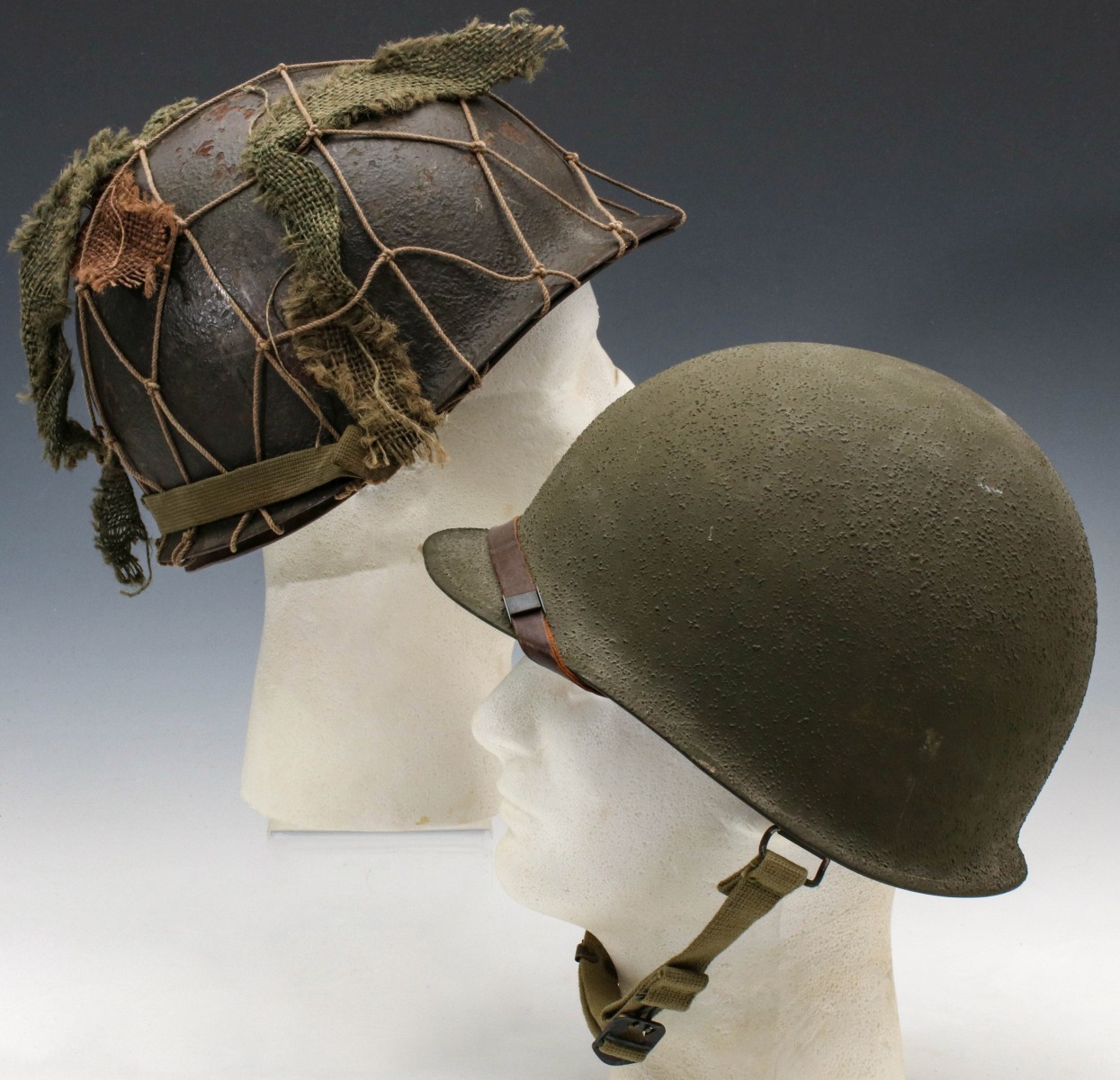 TWO WWII BALE HELMETS