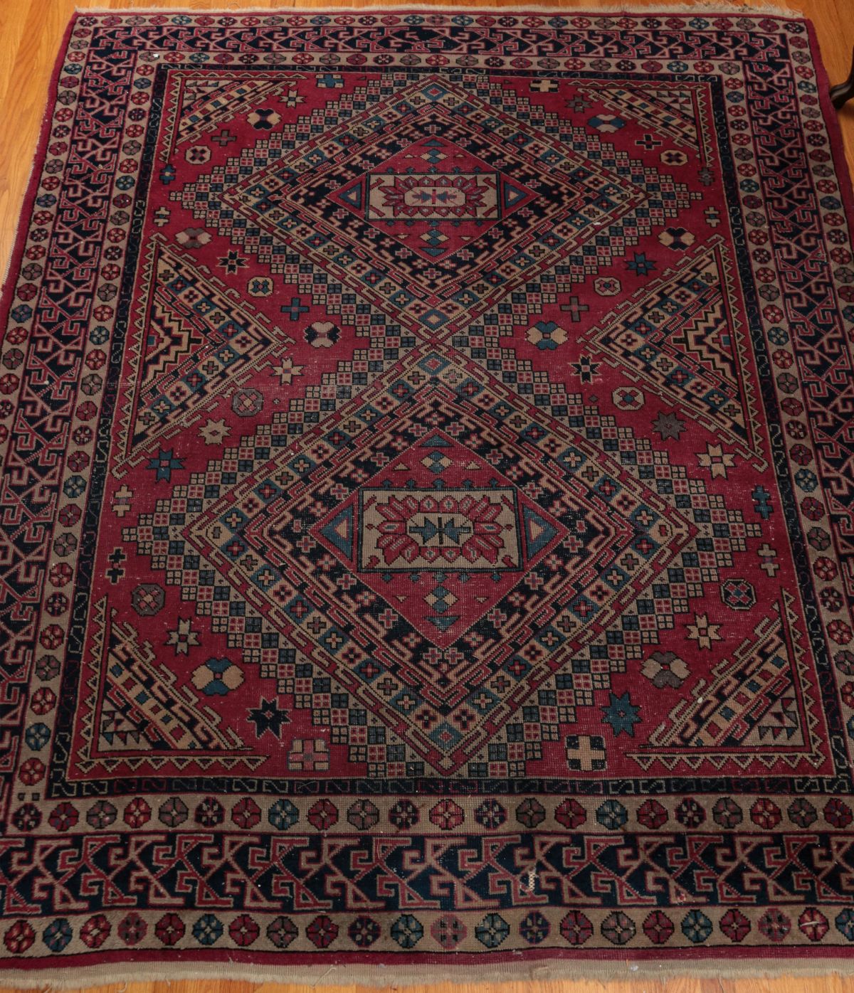 A SEMI-ANTIQUE HAND MADE CAUCASIAN RUG