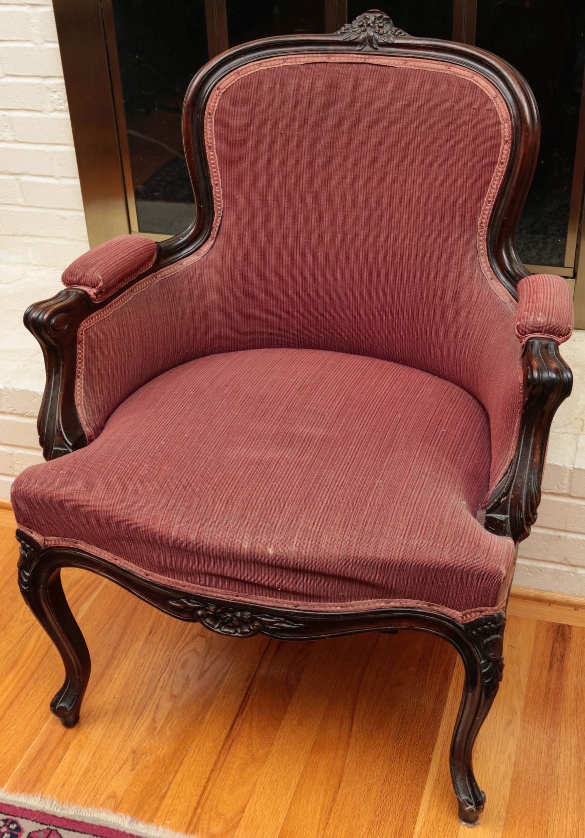 A COUNTRY FRENCH STYLE BERGERE TYPE UPHOLSTERED CHAIR