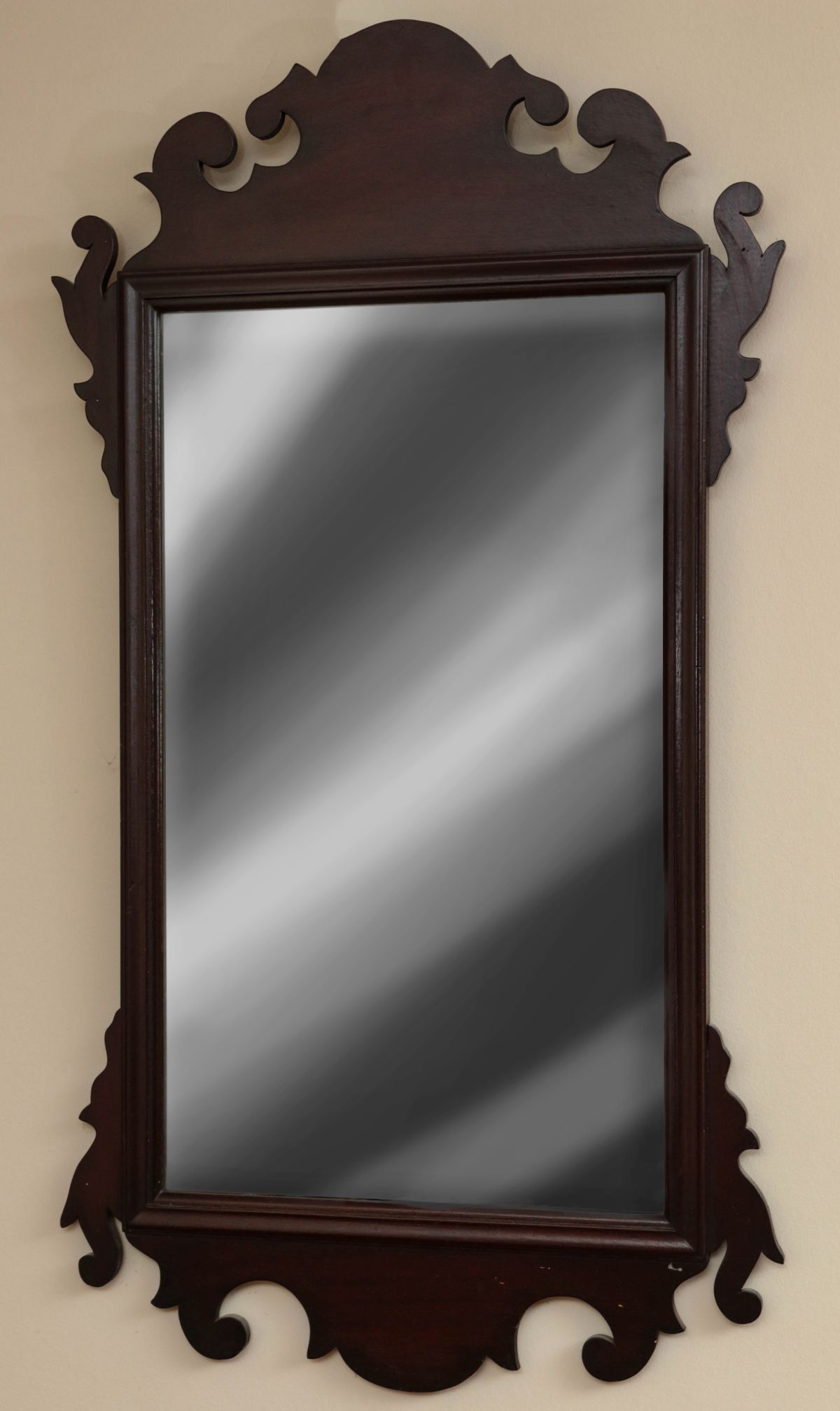 A 1930s CHIPPENDALE STYLE SCROLL CUT MIRROR