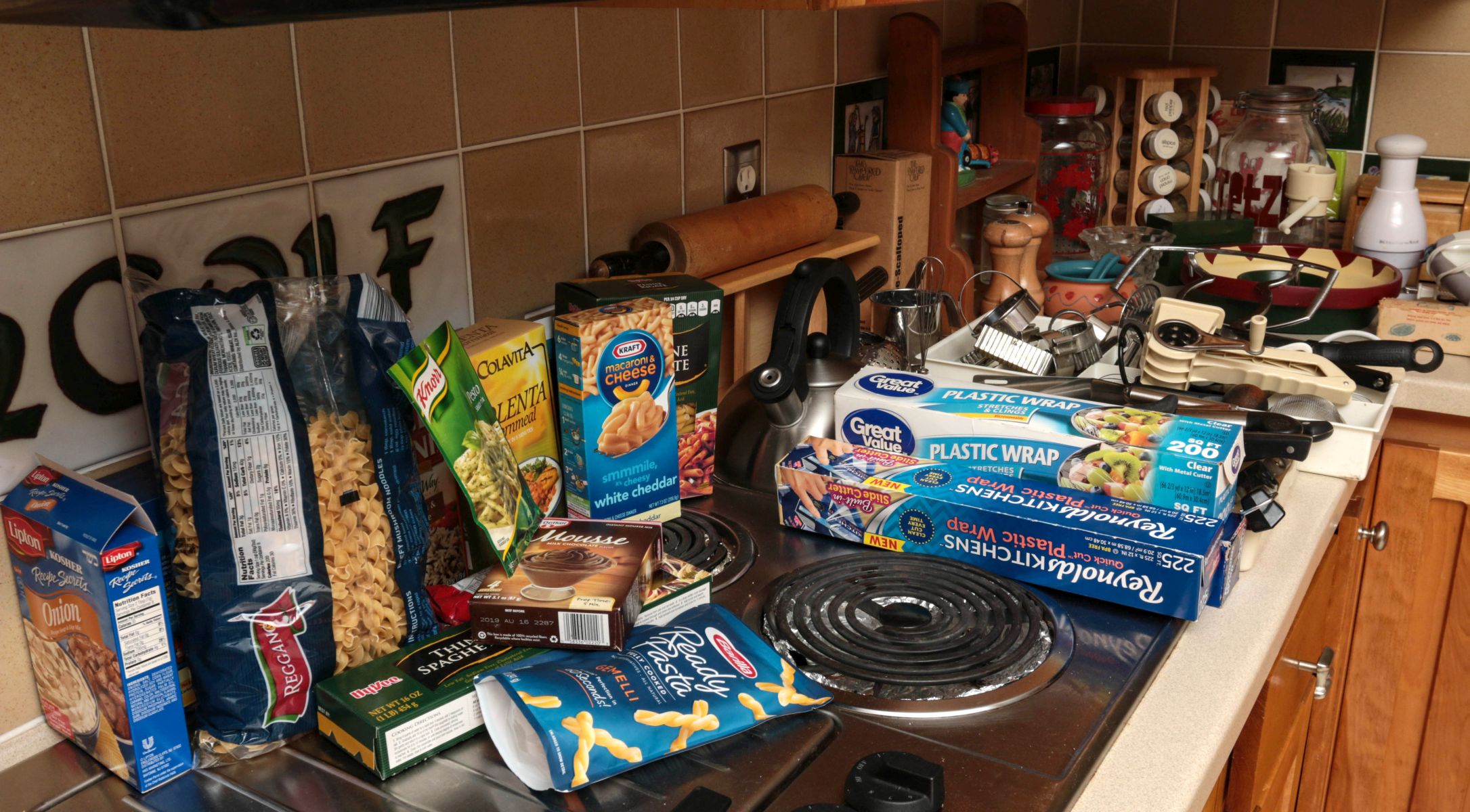 A KITCHEN COUNTER COVERED WITH MISCELLANEOUS