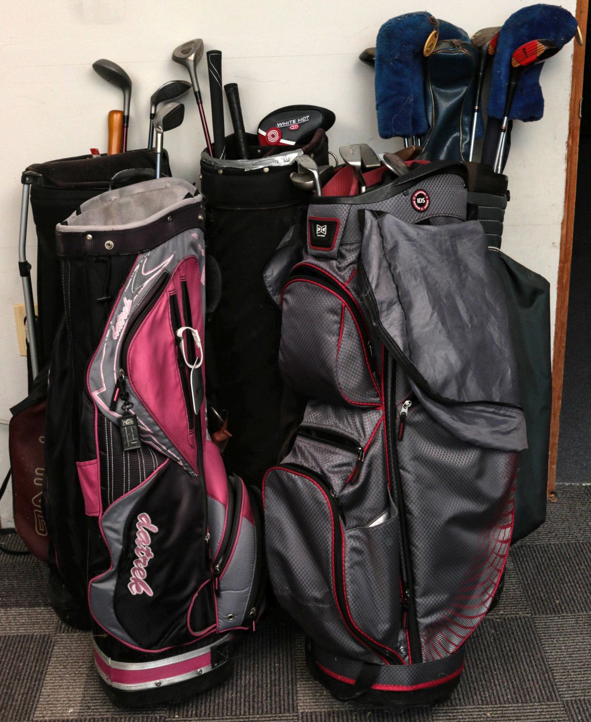 LARGE LOT OF GOLF BAGS AND CLUBS