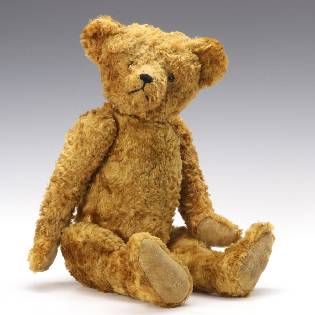 A GOLD PLUSH TEDDY BEAR CIRCA 1920s